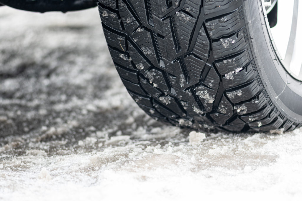 Closeup of car tire on ice